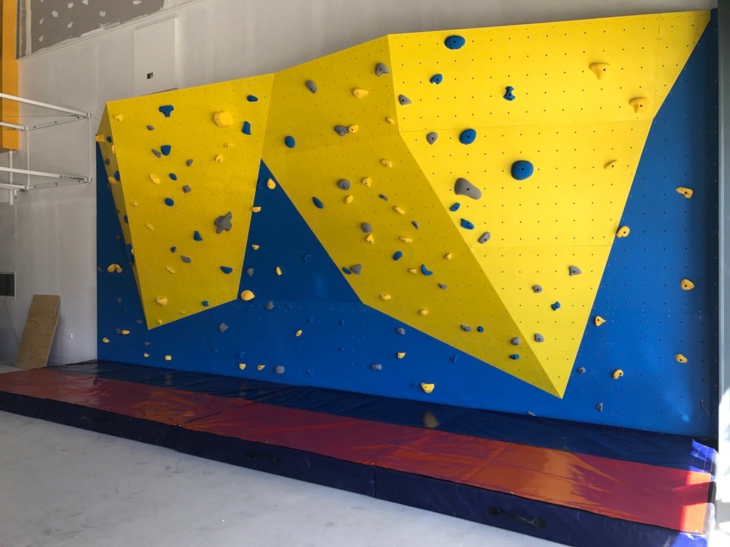 Bouldering wall with yellow and blue panels installed at Wakatipu High School